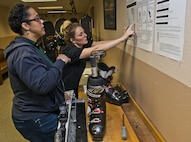 (From left) Dana Sharrit, 5th Force Support Squadron Outdoor Recreation associate, receives training from Ashley Shafer, 5 FSS Outdoor Recreation aid, at Minot Air Force Base, N.D., Dec. 2, 2016. Outdoor Rec. is an organization that gives Airmen and their families the opportunity to experience North Dakota events like skiing, snowboarding and dog sledding. (U.S. Air Force photo/Airman 1st Class Jonathan McElderry)