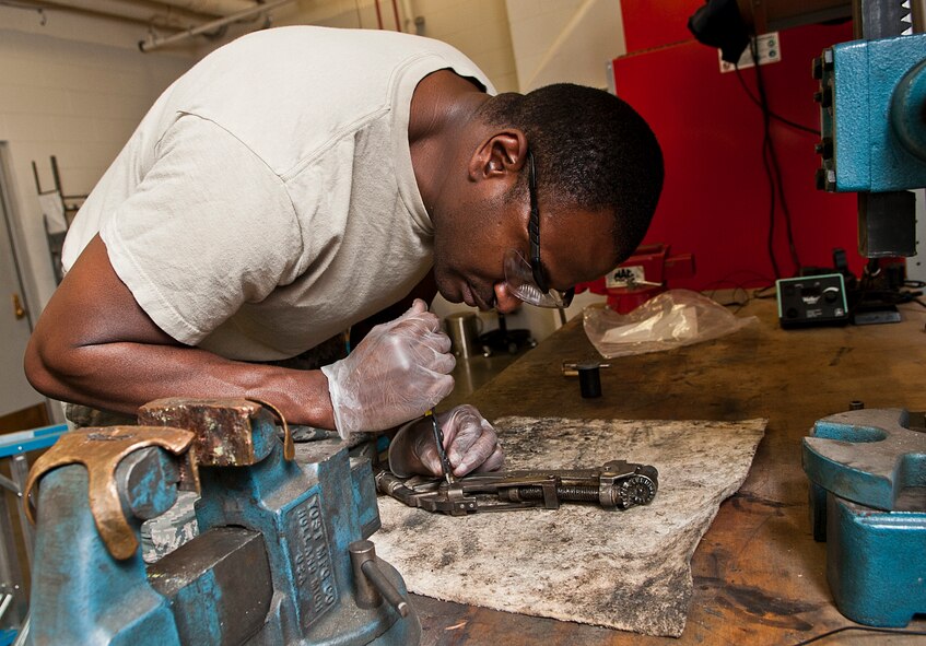 Staff Sgt. Mario Fortenberry, 5th Maintenance Operations flight circuit card repair technician, repairs a J-latch tool at Minot Air Force Base, N.D., Jan. 10, 2017. Air Force Repair Enhancement Program Airmen work on various equipment, from repairing television parts to troubleshooting computer circuit cards. (U.S. Air Force photo/Airman 1st Class Jonathan McElderry)