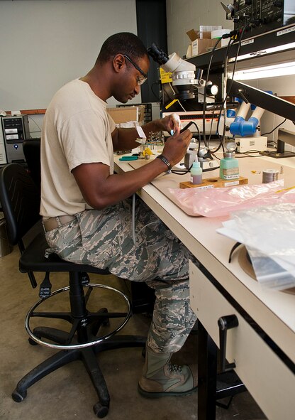 Staff Sgt. Mario Fortenberry, 5th Maintenance Operations flight circuit card repair technician, replaces circuit card assembly components at Minot Air Force Base, N.D., Jan. 10, 2017. Air Force Repair Enhancement Program Airmen work on various equipment, from repairing television parts to troubleshooting computer circuit cards. (U.S. Air Force photo/Airman 1st Class Jonathan McElderry)