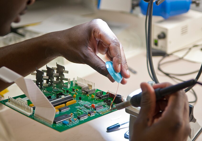 A 5th Maintenance Operations flight Airman wicks solder on a circuit card assembly at Minot Air Force Base, N.D., Jan. 10, 2017. Air Force Repair Enhancement Program Airmen are able to repair almost any circuit card assembly malfunction or defect. (U.S. Air Force photo/Airman 1st Class Jonathan McElderry)