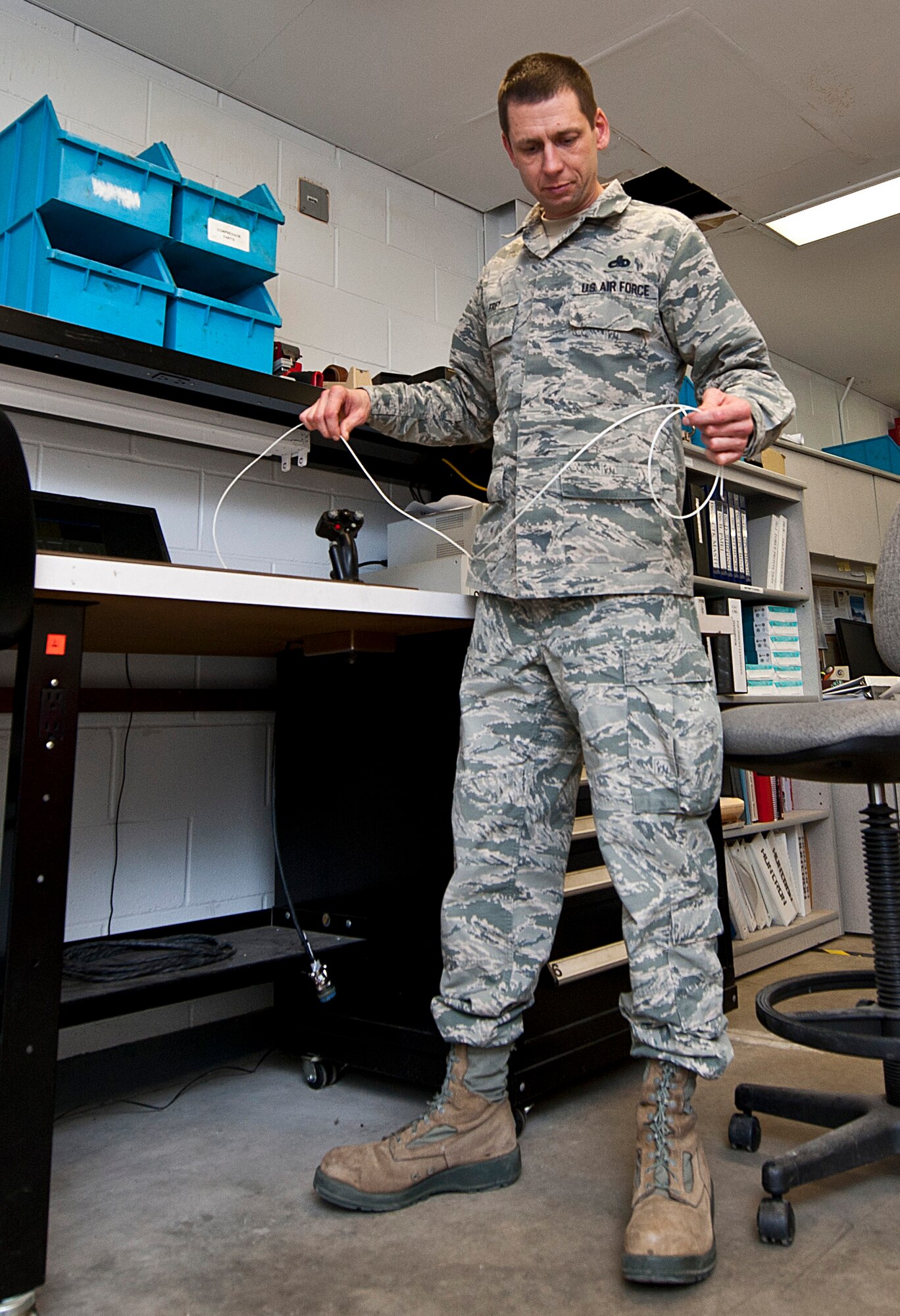Master Sgt. Joseph Frey, 5th Maintenance Operations flight Air Force Repair Enhancement Program manager, unwraps a ground wire at Minot Air Force Base, N.D., Jan. 10, 2017. The AFREP is responsible for preventing the Air Force from spending money to fix equipment initially deemed beyond repair. (U.S. Air Force photo/Airman 1st Class Jonathan McElderry)