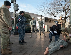 Airman First Class James Horne (left center) and Staff Sgt. Kathryn Cisler (right center), 779th Medical Operations Squadron, train alongside Sailors and Soldiers to simulate first response treatment of a dummy dressed as a military member in the District of Columbia, Jan. 15, 2017. Horne and Cisler are in one of the multiple roving medical teams that will stand ready for any medical emergencies that may occur during the presidential inauguration parade. (U.S. Air Force photo by Staff Sgt. Joe Yanik)