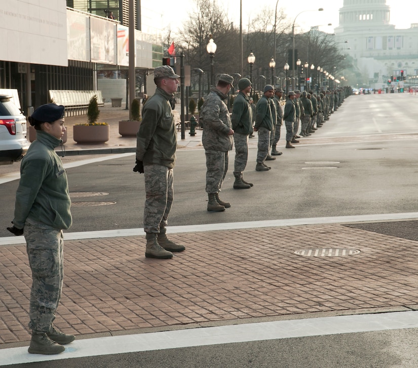 Airmen from the National Capitol Region form a cordon along Pennsylvania Avenue in downtown District of Columbia, Jan. 15, 2017. The Airmen spent several hours over the weekend rehearsing for the upcoming presidential inauguration parade. (U.S. Air Force photo by Staff Sgt. Joe Yanik)