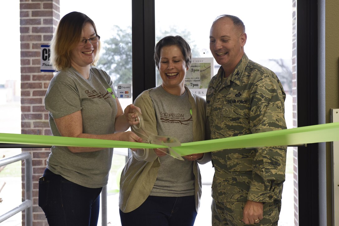 U.S. Air Force Col. Michael Downs, 17th Training Wing Commander, and Goodfellow combined spouses club members cut the grand re-opening ribbon for the Goodfellow Combined Spouses Club Thrift Shop, Jan. 17, 2017. The thrift shop re-opened due to increased base interest and participation. (U.S. Air Force photo by Airman 1st Class Chase Sousa/Released)