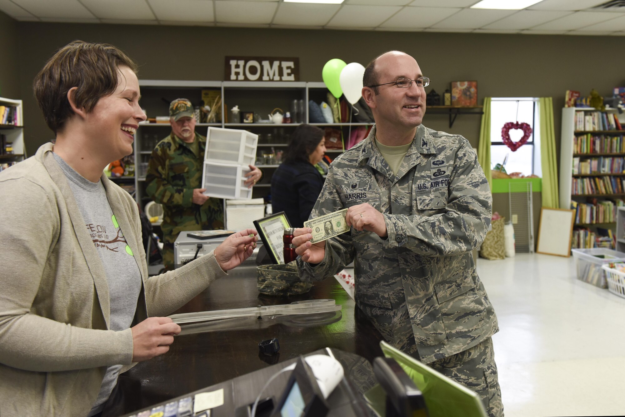 U.S. Air Force Col. Christopher Harris, 17th Mission Support Group Commander, buys an item at the Goodfellow Combined Spouses Club Thrift Shop Jan. 17, 2017. Harris is the first sale of the thrift shop since its re-opening. (U.S. Air Force photo by Airman 1st Class Chase Sousa/Released)