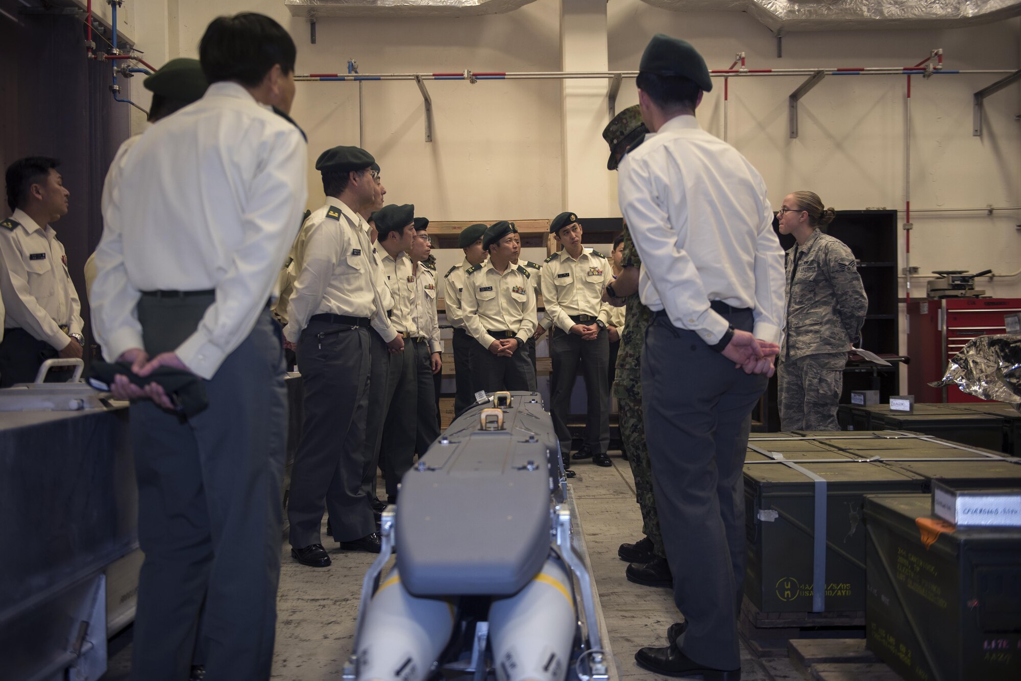 Members of the Japan Ground Self-Defense Force learn about different pieces of munitions equipment during a tour of the 18th Munitions Squadron Jan. 11, 2017, at Kadena Air Base, Japan. These work and cultural exchanges strengthen the bilateral relationship between the two partner services by exchanging ideas and creating a stronger bond. (U.S. Air Force photo by Airman 1st Class Corey Pettis/Released)