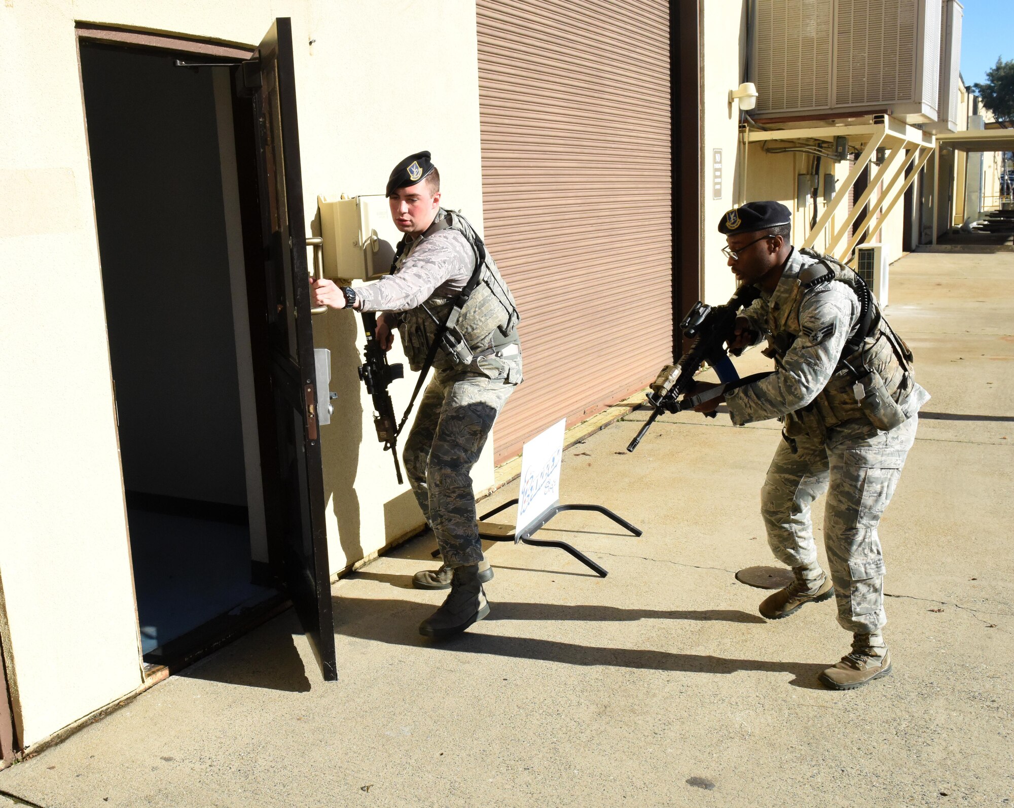 9th Security Forces Squadron Airmen enter a building during an active shooter exercise after arriving on scene Jan. 13, 2017 at Beale Air Force Base, California. The exercise took place in a building on the flightline and began at approximately 10 a.m. (U.S. Air Force photo/John Schwab)