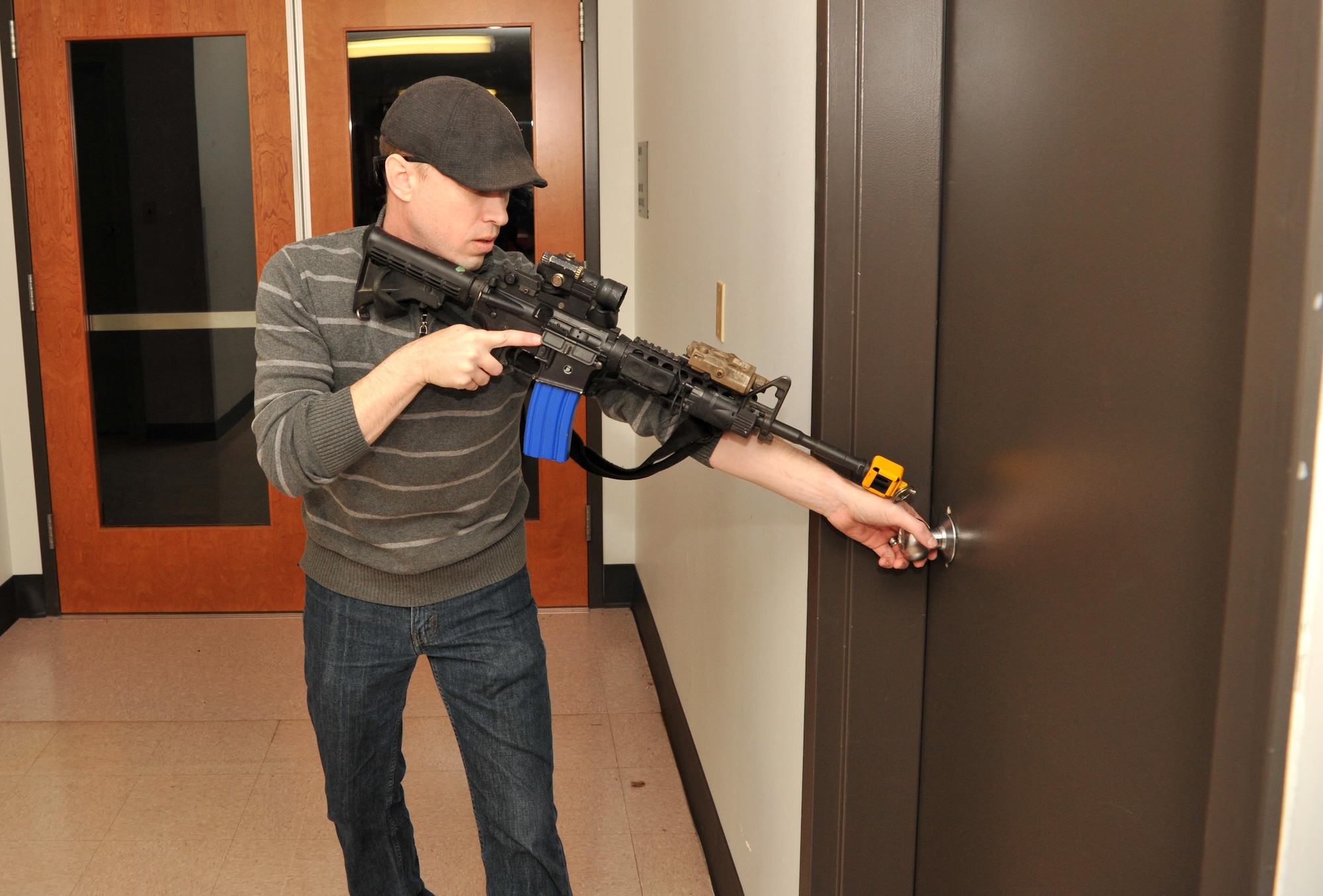 Staff Sgt. Chris Hall, a 9th Security Forces member, plays the role of an active shooter during an exercise Jan. 13, 2017 at Beale Air Force Base, California. The protocol during an active shooter scenario is to lock all doors and turn of lights in order to remain hidden. (U.S. Air Force photo/Airman Tristan D. Viglianco)