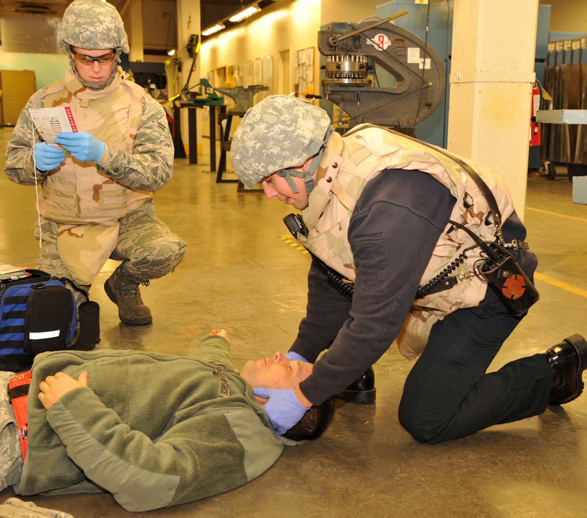 First responders assess and treat a wounded Airman during an active shooter exercise Jan. 13, 2017 at Beale Air Force Base, California. The first responders began treating the victims once the building was secured by the 9th Security Forces Squadron. (U.S. Air Force photo/Airman Tristan D. Viglianco)