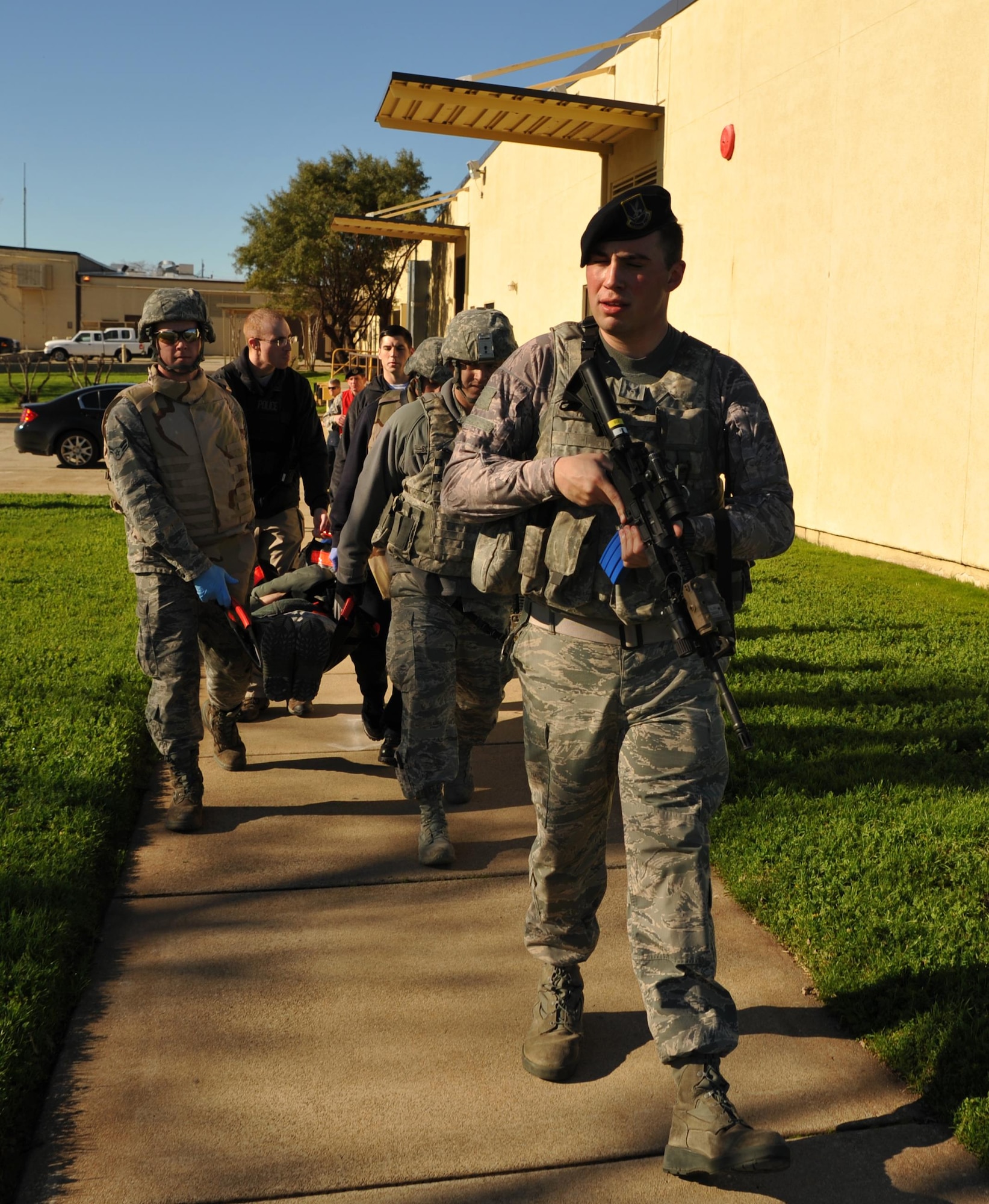 9th Security Forces personnel and first responders evacuate a wounded Airman during an active shooter exercise Jan. 13, 2017 at Beale Air Force Base, California. The exercise helped prepare units on base in the case of a real-world scenario. (U.S. Air Force photo/Airman Tristan D. Viglianco)