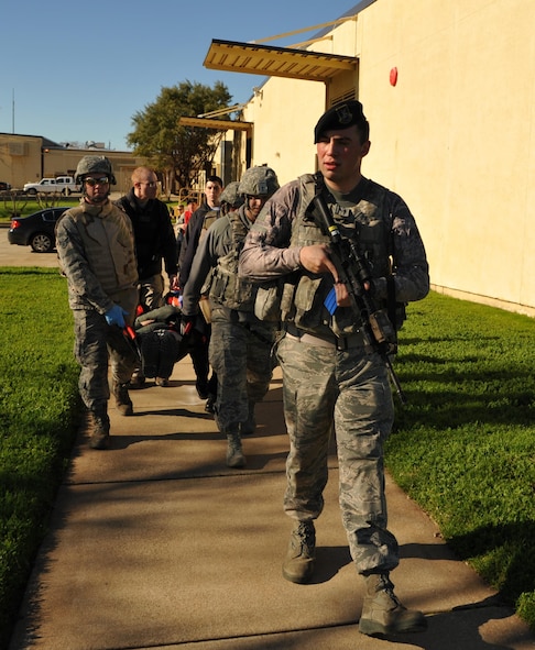 9th Security Forces personnel and first responders evacuate a wounded Airman during an active shooter exercise Jan. 13, 2017 at Beale Air Force Base, California. The exercise helped prepare units on base in the case of a real-world scenario. (U.S. Air Force photo/Airman Tristan D. Viglianco)