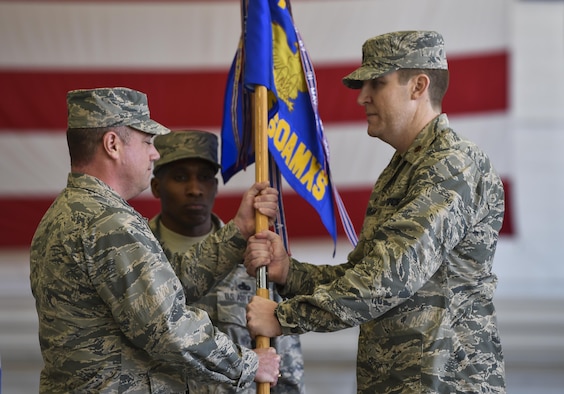 Col. Harry Seibert, commander of the 1st Special Operations Maintenance Group, presents Maj. Bryan Hogan, commander of the 801st Special Operations Aircraft Maintenance Squadron, with the 801st SOAMXS guidon during a change of command ceremony at Hurlburt Field, Fla., Jan. 12, 2017. Maj. Bryan Hogan took command of the 801st SOAMXS from outgoing commander, Lt. Col. Philip Broyles. (U.S. Air Force photo by Airman 1st Class Joseph Pick)
