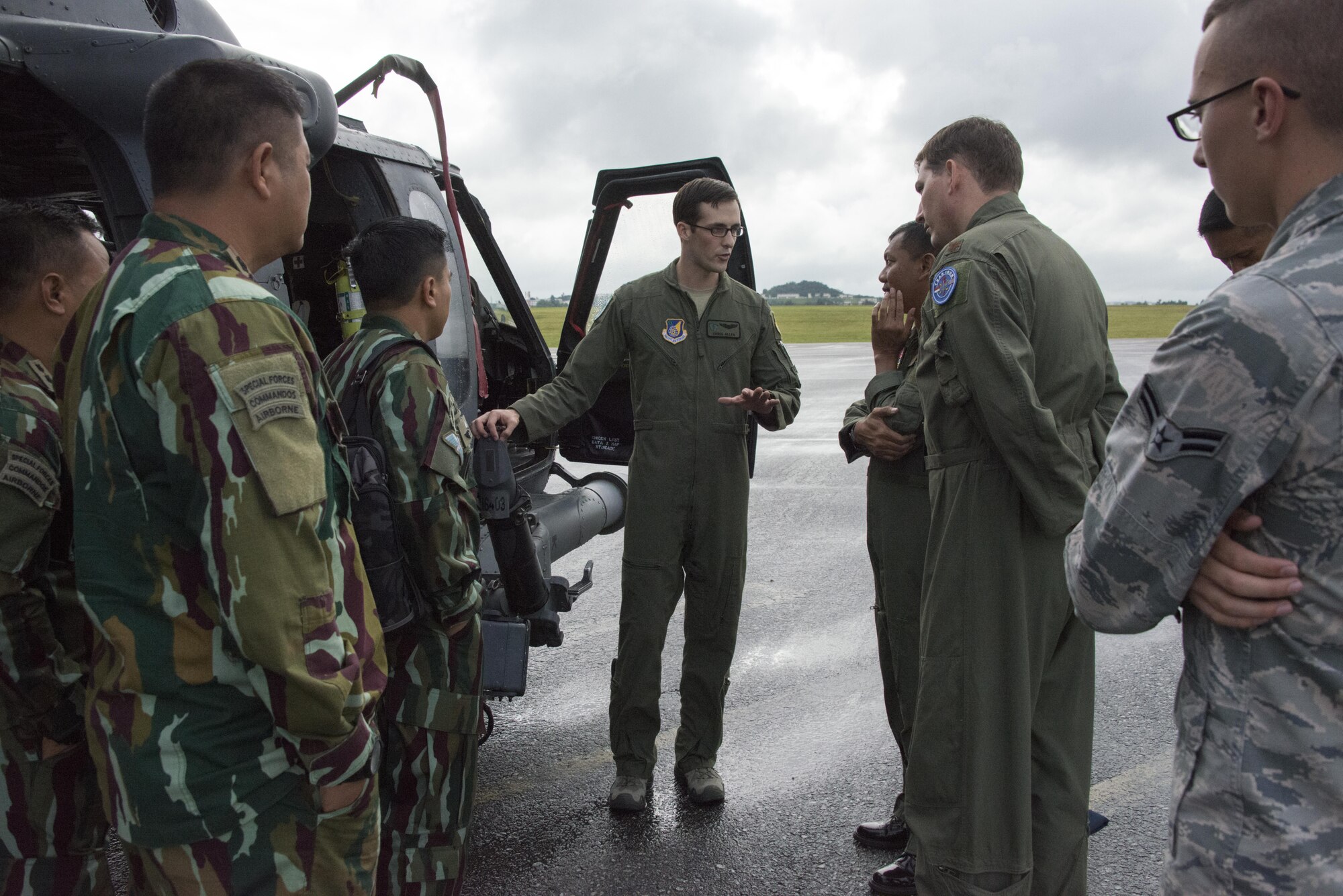 Capt. Chris Allen, 33rd Rescue Squadron pilot, explains the features of the HH-60 Pave Hawk to Indonesian Air Force leadership during a flightline tour, December 5, 2016. Joint Special Operations Command-Pacific (JSOAC-P) demonstrated the benefits of continual partnership building during a visit by Indonesian Air Force leadership to Kadena Air Base, December 4-8, 2016. (U.S. Air Force photo by Capt. Jessica Tait)