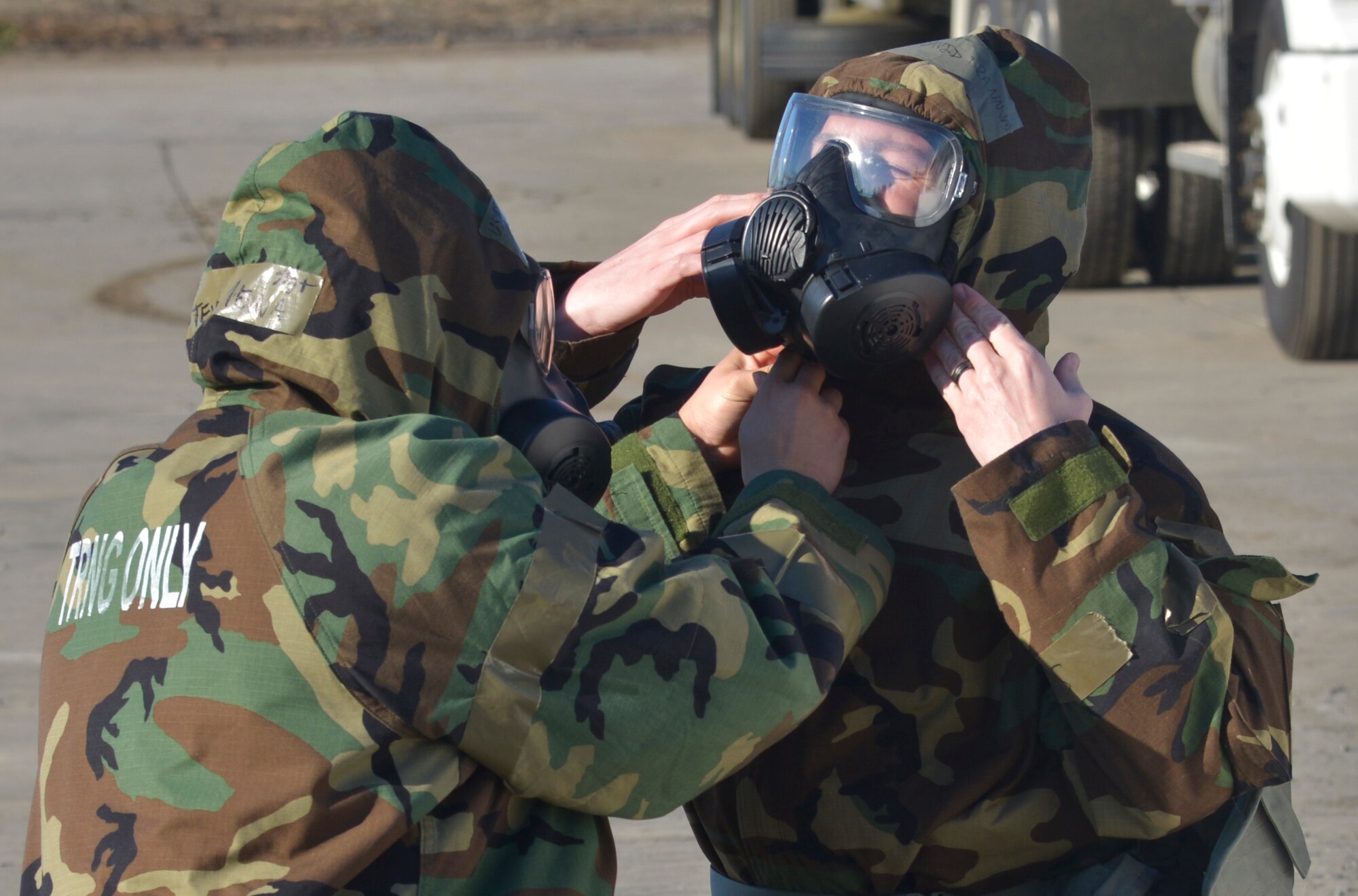 Members of the 374th Civil Engineer Squadron dawn chemical, biological, radiological and nuclear gear during a simulated crater repair scenario at Yokota Air Base, Japan, Jan. 12, 2017. The training provides Airmen with the opportunity to practice and hone their skillset for potential real world scenarios. (U.S. Air Force photo by Staff Sgt. David Owsianka)