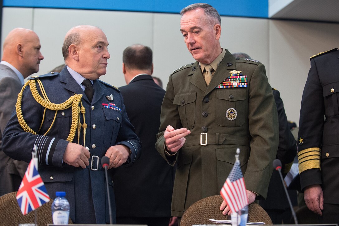 Marine Corps Gen. Joe Dunford, chairman of the Joint Chiefs of Staff, speaks with Air Chief Marshal Stuart Peach, the British defense chief, before a NATO meeting in Brussels, Jan. 17, 2017. DoD photo by Army Sgt. James K. McCann