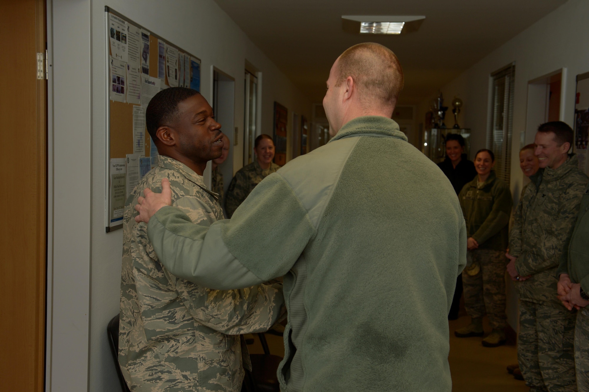 Master Sgt. Jamain Rouse, 52nd Force Support Squadron first sergeant, is coined by Chief Master Sgt. Edwin Ludwigsen, 52nd Fighter Wing command chief, for his actions in a Green Dot social experiment at Spangdahlem Air Base, Germany, Jan. 11, 2017. Green Dot has been conducting several scenarios around base to see how individuals will react to the actors. (U.S. Air Force photo by Staff Sgt. Jonathan Snyder)