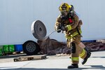 A 380th Expeditionary Civil Engineering Squadron firefighter throws a hose during a timed firefighter confidence course at an undisclosed location in Southwest Asia, Jan. 16, 2017. Wearing up to 75 pounds of equipment, participants completed nine stages during the course including a ladder climb, hose drag, sled pull, hose throw, equipment carry, forcible entry, hotel pack, equipment hoisting and rescue. (U.S. Air Force photo/Senior Airman Tyler Woodward)