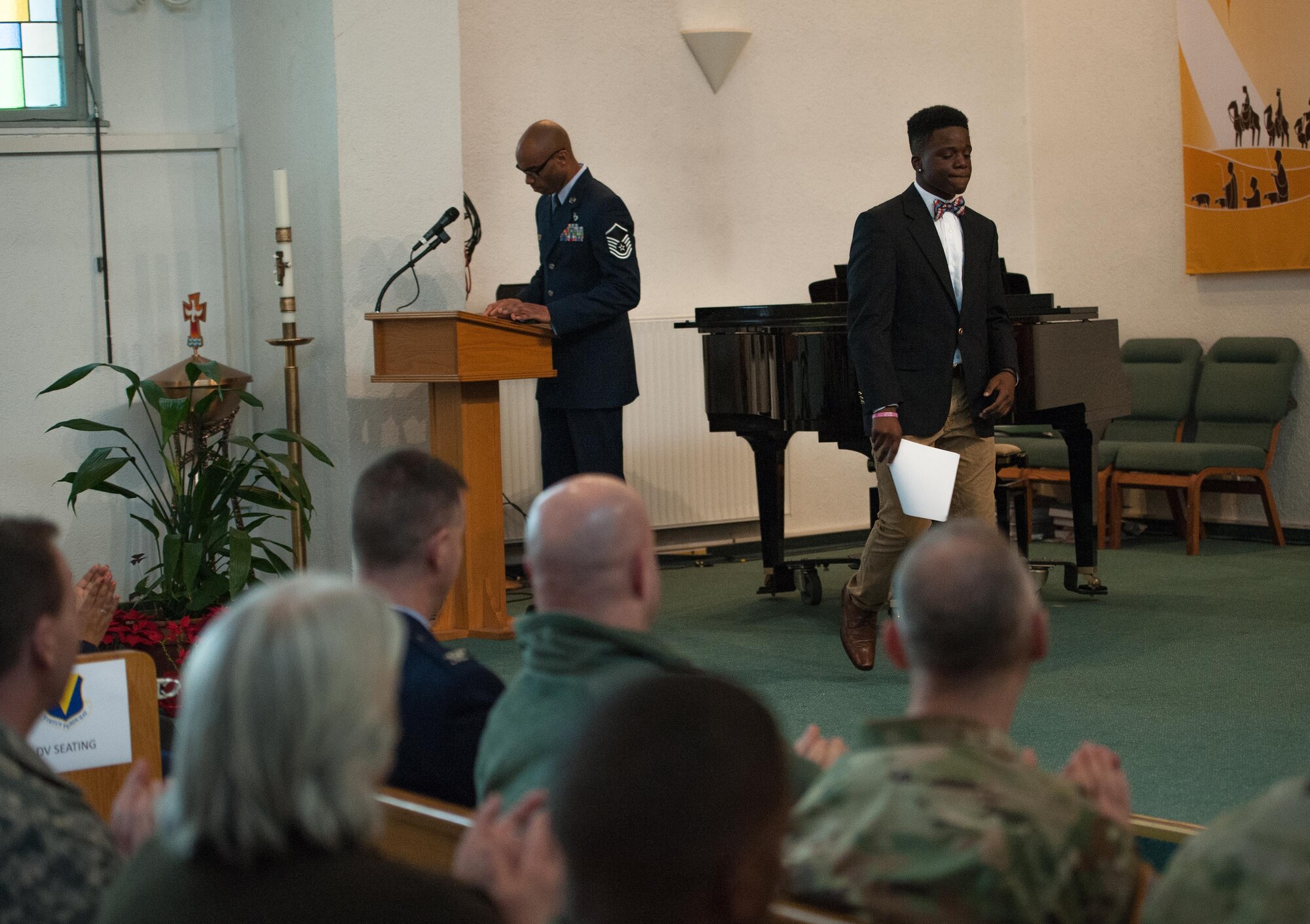 Christian Miley, a high school student, exits the stage after giving a speech during a Martin Luther King Jr. commemoration at Ramstein Air Base, Germany, Jan. 13, 2017. Dr. King was a gifted public speaker at a young age, becoming the youngest assistant manager in his local paper’s history and was a leading member of his high school debate team. (U.S. Air Force photo by Airman 1st Class Lane T. Plummer)