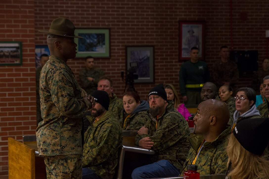 Staff Sergeant Marquise A. Dixon, a drill instructor with Support Battalion, gives the educators and influencers of Orlando and Fort Lauderdale a brief about the beginning of recruit training aboard Marine Corps Recruit Depot Parris Island, South Carolina, January 11, 2017. The educators come from both Recruiting Station Fort Lauderdale and Recruiting Station Orlando to experience what is called the Educators Workshop. The Educators Workshop provides the opportunity for educators to have an inside look at Marine Corps training to better inform their students in their local area. (Photo by Cpl. John-Paul Imbody/Released)