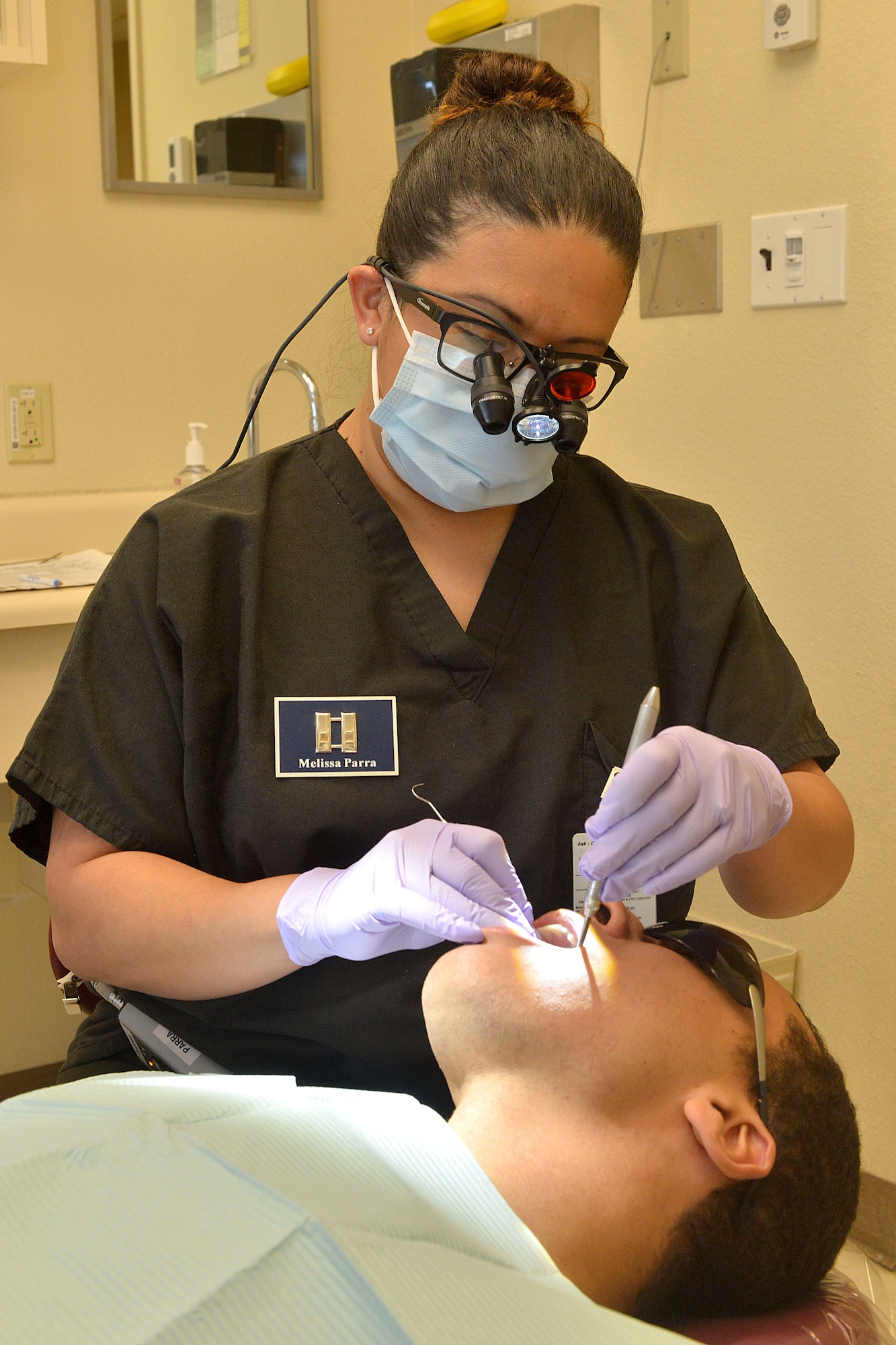 Capt. Melissa Parra, 5th Medical Operations Squadron clinical flight commander, performs an examination on a patient at Minot Air Force Base, N.D., Jan. 10, 2017. Examinations are helpful in determining gum health, and detecting oral cancer, and caries, better known as cavities. (U.S. Air Force photo/Airman 1st Class Jessica Weissman)