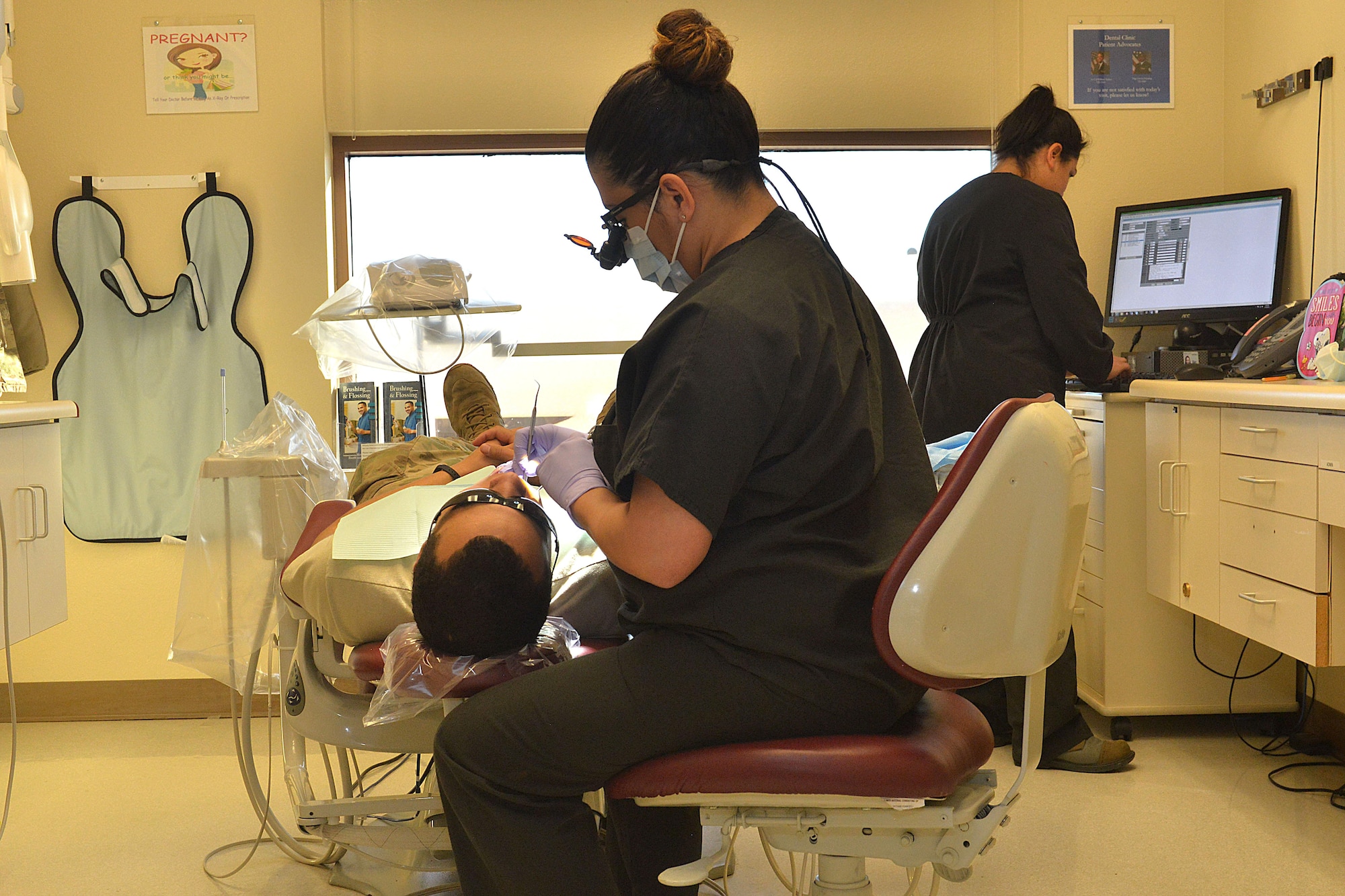 Airmen from the 5th Medical Group dental clinic complete an examination at Minot Air Force Base, N.D., Jan. 10, 2017. The 5th MDG dental clinic is preparing for Children's Dental Health Month, which promotes healthy habits to children. (U.S. Air Force photo/Airman 1st Class Jessica Weissman)