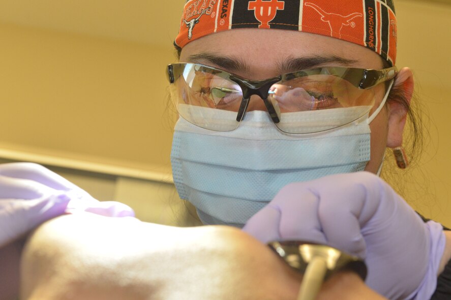 Staff Sgt. Stephanie Garica, 5th Medical Operations Squadron NCO in charge of preventive dentistry, conducts a cleaning at Minot Air Force Base, N.D., Jan. 10, 2017. The 5th Medical Group dental clinic is preparing for Children's Dental Health Month, which promotes healthy habits to children. (U.S. Air Force photo/Airman 1st Class Jessica Weissman)