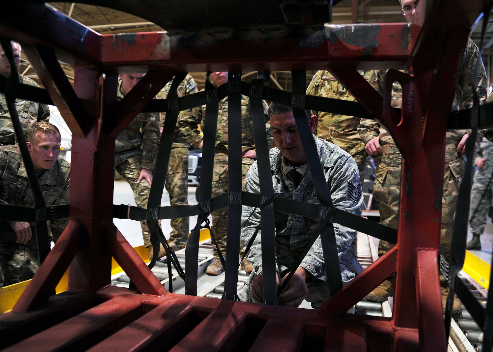 Tech. Sgt. John McDaniel, 27th Special Operations Logistics Readiness Squadron, demonstrates proper air drop bundle securing practices during the Green Beret Experience, Dec. 12, 2016 at Cannon Air Force Base, N.M. In addition to creating the bundles, U.S. Army Green Berets taught participants to call the airdrops in to aircraft, and prepare a drop zone. (U.S. Air Force photo by Staff Sgt. Whitney Amstutz/Unreleased)