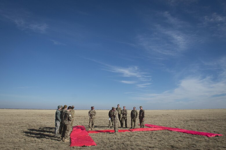 Airmen participating in the Green Beret Experience set up a target for an airdrop Dec. 13, 2016, at Melrose Air Force Range, N.M. Airmen assigned to Cannon Air Force Base, N.M., were trained and tutored by U.S. Army Green Berets over a four day period to get an in-depth experience of all the facets of tactical ground operations. (U.S. Air Force photo by Senior Airman Shelby Kay-Fantozzi/Unreleased)