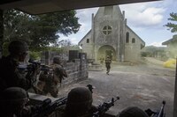 Marines with Echo Company, Battalion Landing Team, 2nd Battalion, 5th Marines, 31st Marine Expeditionary Unit, maneuver through a combat town while conducting a mechanized raid as part of the Marine Expeditionary Unit Exercise at Marine Corps Base Camp Butler, Okinawa, Japan, Jan. 16, 2017. MEUEX integrates aviation, ground and logistics elements to build the interoperability between the components of the Marine Air-Ground Task Force.