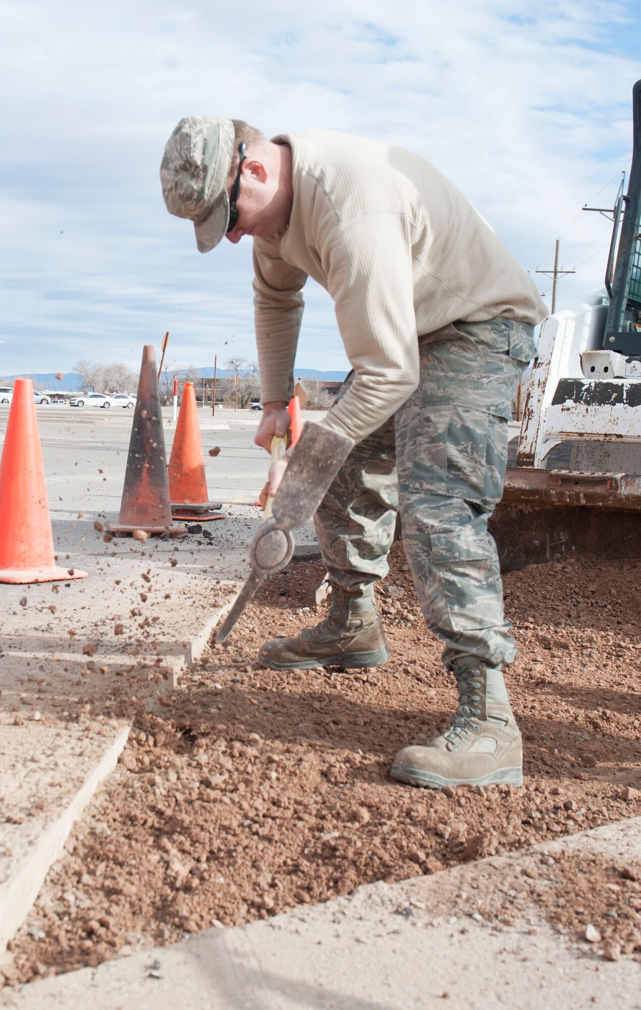 Senior Airman Alec Bacon, a Pavements and Equipment craftsman, assigned to the 49th Civil Engineer Squadron, loosens up hardened soil at Holloman Air Force Base, N.M., January 17, 2017. In order for asphalt to be placed onto the surface smoothly, the soil underneath it must be as smooth as possible. A utility break occurred under the roadway causing for the 49th CES to quickly respond and fix the problem. (U.S. Air Force photo by Airman Ilyana A. Escalona)