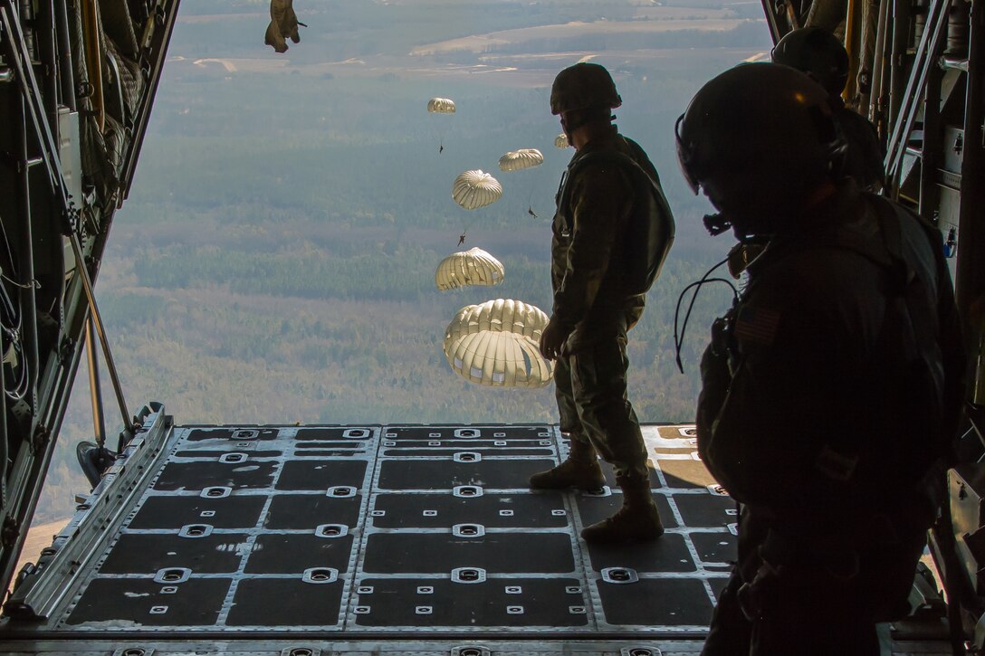 U.S. Soldiers assigned to the 421st Quartermaster Company, U.S. Army Reserve, perform a static line jump out of a C-130 Hercules belonging to the Missouri Air National Guard’s 180th Airlift Squadron over Sylvania, Ga., on January 10, 2017. 