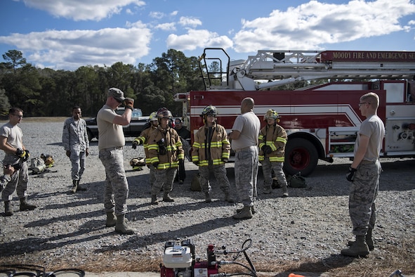 Members of an Emergency Medical Technician refresher course, listen to final instructions, during Vehicle Extrication training, Jan. 13, 2017, at Moody Air Force Base, Ga. The students donned the top half of the protective gear to shield them from any debris during the training. (U.S. Air Force photo by Airman 1st Class Janiqua P. Robinson)