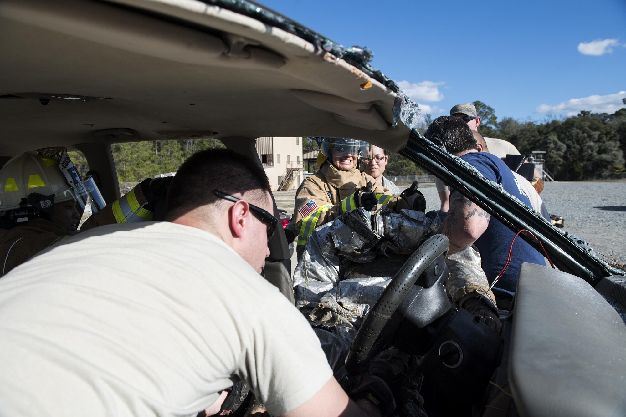 Participants work as a team to remove a simulated patient from a vehicle, during Vehicle Extrication training, Jan. 13, 2017, at Moody Air Force Base, Ga. In a real world extrication, firefighters would arrive on scene, ensure the car was safe and get the patient out as quickly as possible to prevent further injury. (U.S. Air Force photo by Airman 1st Class Janiqua P. Robinson)