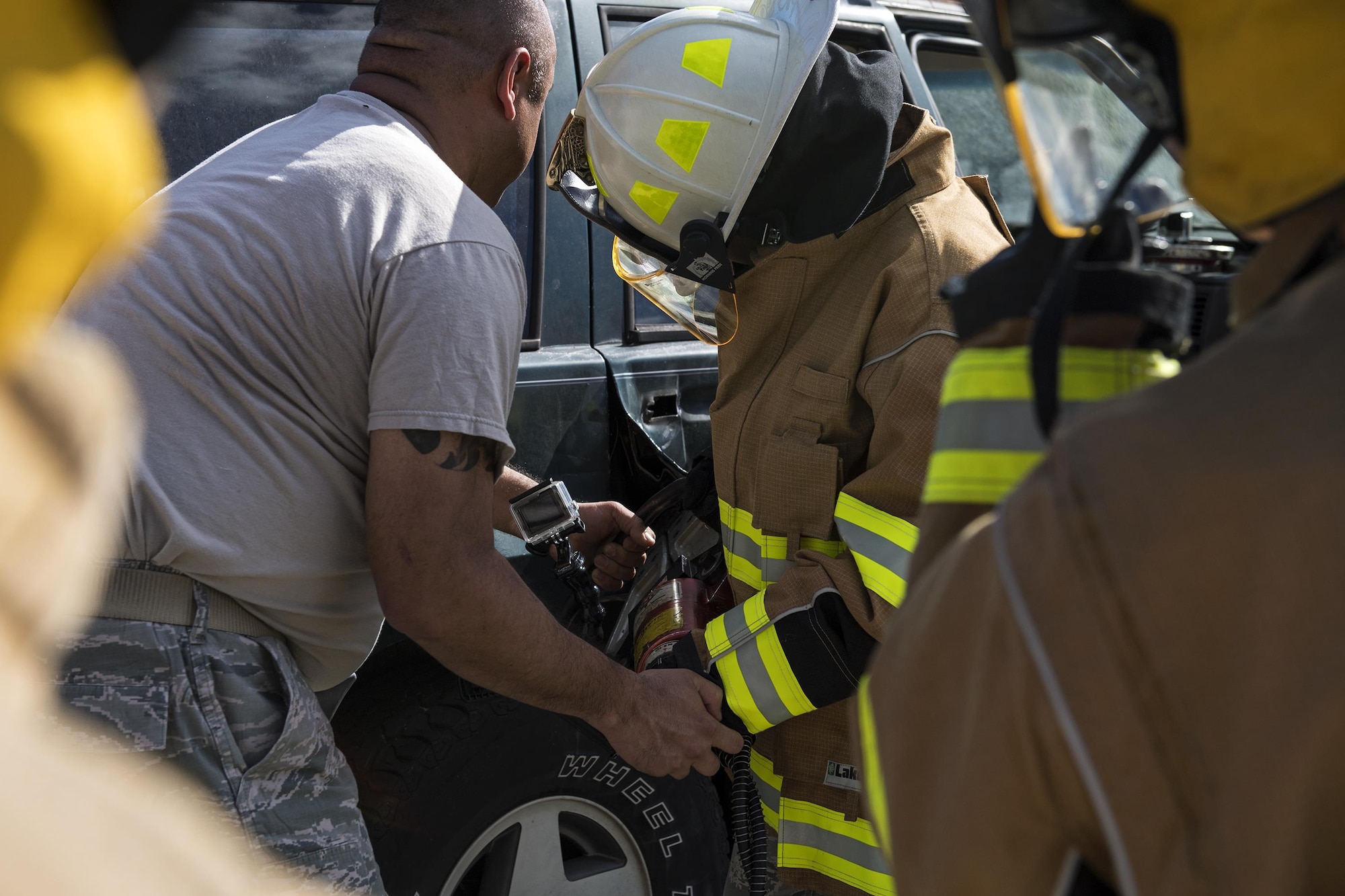 An instructor guides a student using a spreader, also known as the jaws of life, during Vehicle Extrication training, Jan. 13, 2017, at Moody Air Force Base, Ga. The instructor showed the student to keep an eye out for openings the spreader created, then close the spreader, and force it into those openings to get the door off faster. (U.S. Air Force photo by Airman 1st Class Janiqua P. Robinson)