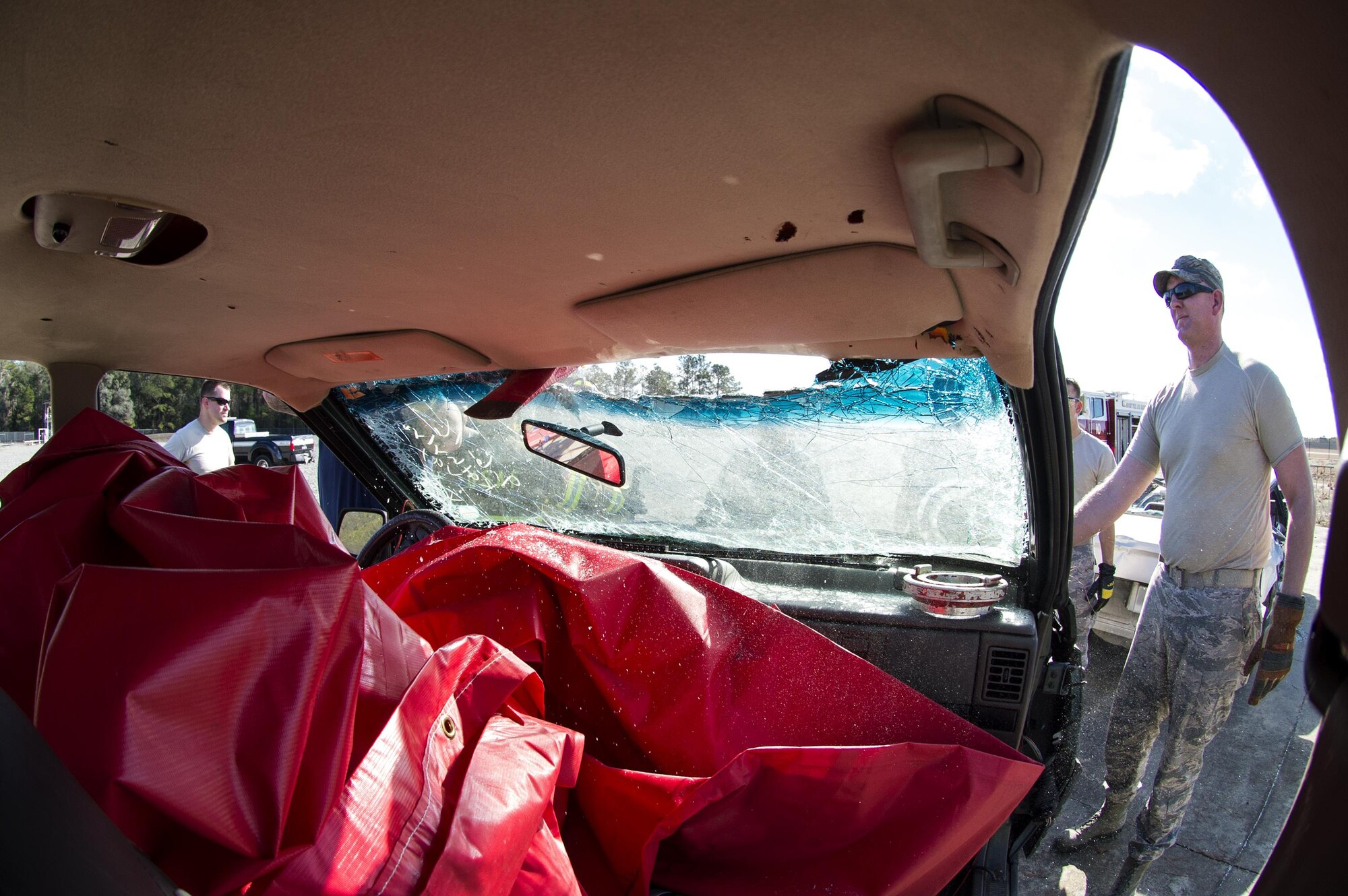A participant uses an axe to cut through a windshield, during Vehicle Extrication training, Jan. 13, 2017, at Moody Air Force Base, Ga. After loosening the windshield from the supports, firefighters can fold it over the hood or completely remove the windshield depending on how they want to remove the patient from the vehicle. (U.S. Air Force photo by Airman 1st Class Janiqua P. Robinson)
