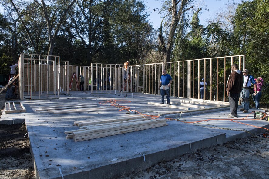 Volunteers work on various parts of a house for Habitat for Humanity, Jan. 14, 2017, in Valdosta, Ga. Typically, Habitat for Humanity would already have the frames of the house prebuilt for volunteers to place, but these volunteers built the frames themselves. (U.S. Air Force photo by Airman 1st Class Janiqua P. Robinson)