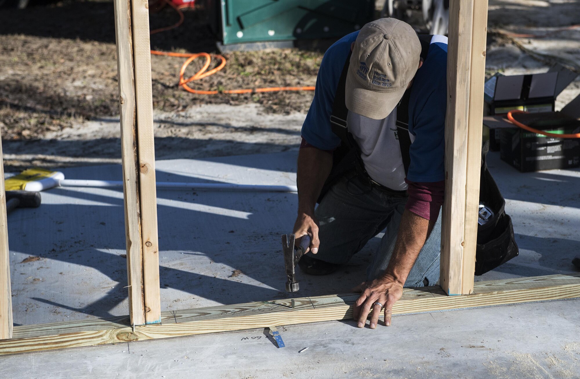 A volunteer hammers a stud into the frame of a house for Habitat for Humanity, Jan. 14, 2017, in Valdosta, Ga. Their goal is to get the roof on the five-bedroom home by Jan. 27, to prevent any interior weather damage. (U.S. Air Force photo by Airman 1st Class Janiqua P. Robinson)