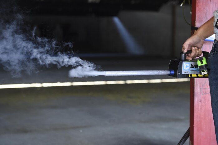 Megan Steele, 711th Human Performance Wing, Wright-Patterson Air Force Base, Ohio, Airman Systems Directorate engineer, uses smoke to learn which direction the air flows at the Combat Arms Training and Maintenance firing range at Joint Base Charleston, South Carolina, Nov. 17, 2016. Steele and her fellow researchers came here to conducts tests on the fumes expended from firing a weapon on firing ranges.
