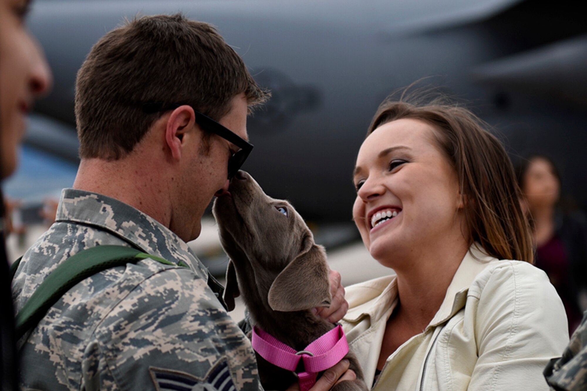 PETERSON AIR FORCE BASE, Colo. – An Airman from the 302nd Airlift Wing returns from deployment to meet his significant other and new puppy on the flightline at Peterson Air Force Base, Colo., May 18, 2016. (U.S. Air Force photo by Senior Airman Rose Gudex)