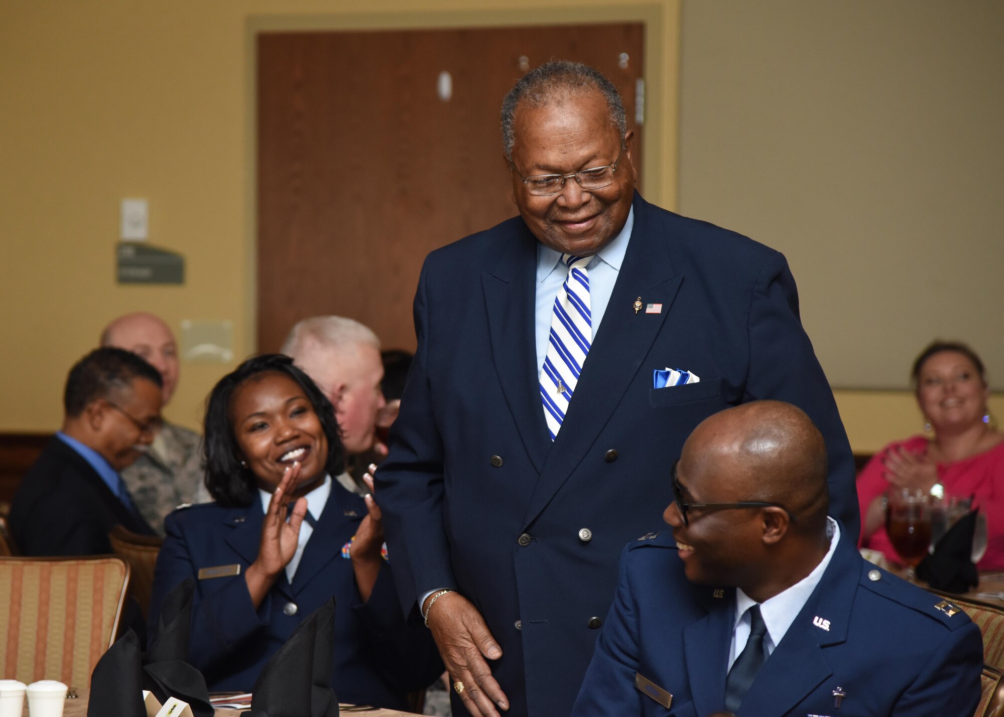 Audience members applaud retired Chief Master Sgt. Chris Moore at the annual Rev. Dr. Martin Luther King Jr. Memorial Luncheon at the Bay Breeze Event Center, Jan. 17, 2017, on Keesler Air Force Base, Miss. The Keesler African-American Heritage Committee sponsored event honored King’s legacy and his efforts to inspire civil rights activism within the African-American community. (U.S. Air Force photo by Kemberly Groue)