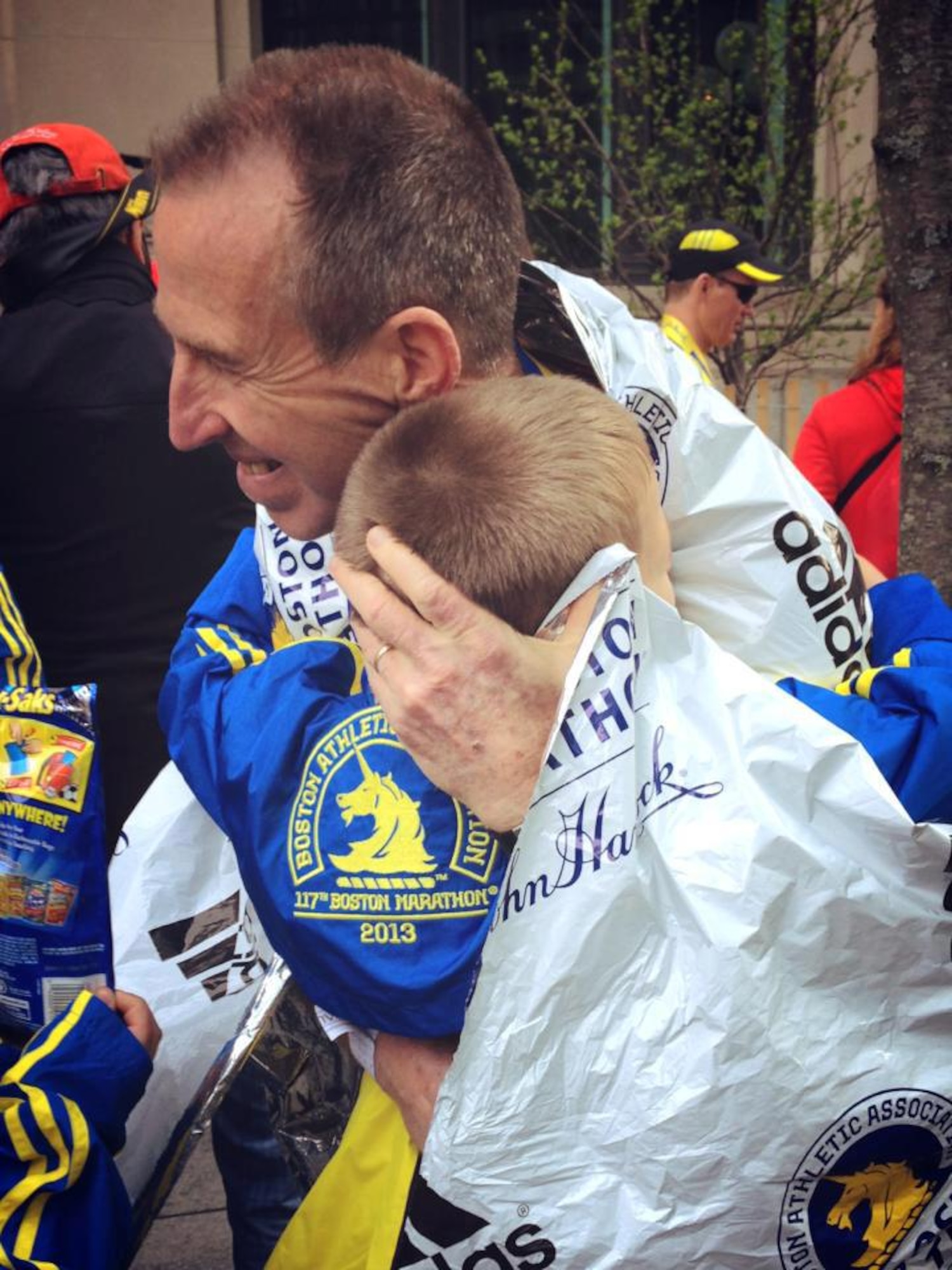 Dave Nickell, unit deployment manager with the 477th Fighter Group at Joint Base Elmendorf-Richardson, Alaska, embraces his family after completing his first Boston Marathon April, 2013, shortly before a bomb went of at the finish line. Nickell remembers the Boston Marathon tragedy of 2013 while training for the 2017 race.