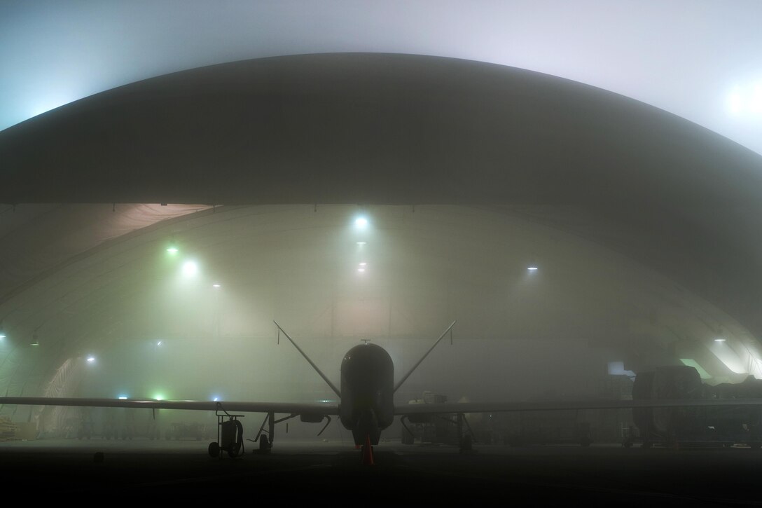 A Global Hawk awaits standard maintenance while a heavy fog rolls across the flight line in Southwest Asia, Jan. 12, 2017. Global Hawks have provided coalition partners with accurate intelligence necessary for precisely striking important facilities and supply routes in support of Combined Joint Task Force Operation Inherent Resolve. Air Force photo by Senior Airman Tyler Woodward