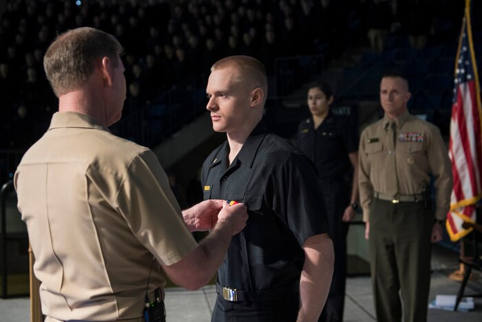 Navy Vice Adm. Ted Carter, the superintendent of the U.S. Naval Academy, left, presents the Navy and Marine Corps Medal to Midshipman 3rd Class Jonathan Dennler during a ceremony at Alumni Hall in Annapolis, Md., Jan. 9, 2017. Dennler received the medal for his heroic actions while leading a Boy Scout troop. Navy photo by Kenneth Aston