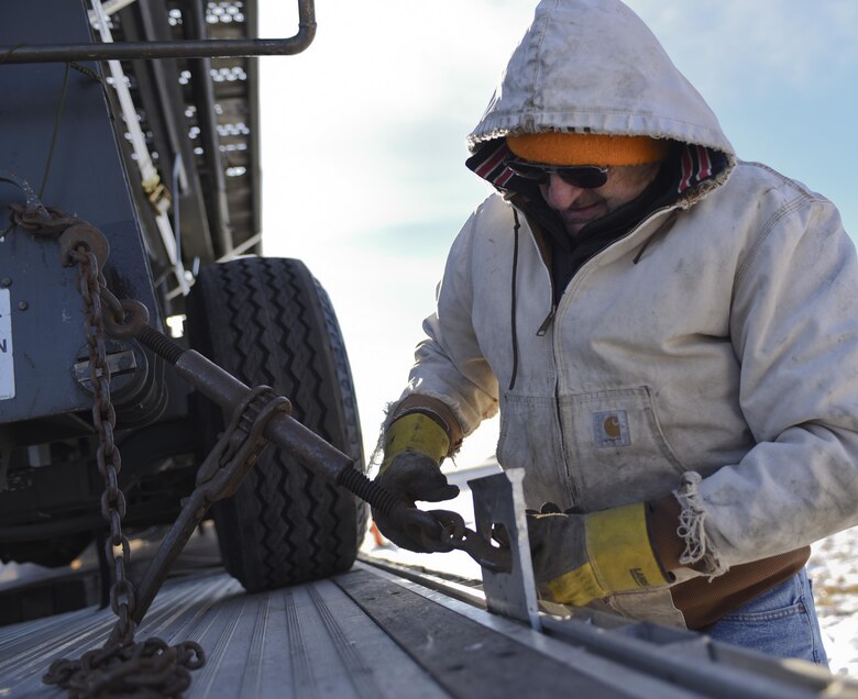 Keith Wilson, a truck driver with the 28th Logistics Readiness Squadron, fastens equipment to a truck Jan. 17, 2017, at Ellsworth Air Force Base, S.D. The platforms, generators, flood lights and other equipment loaded will be used at Red Flag 17-1—an Air Force-wide exercise testing air-to-air combat. (U.S. Air Force photo by Airman 1st Class Randahl J. Jenson)