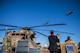 Attendees of a MH-53J Pave Low III dedication ceremony watch as two CV-22 Osprey aircraft conduct a flyover Jan 17, 2017, at the air park on Cannon Air Force Base, N.M. The flyover concluded the ceremony in which more than 150 people were in attendance. (U.S. Air Force photo by Senior Airman Luke Kitterman/Released) 