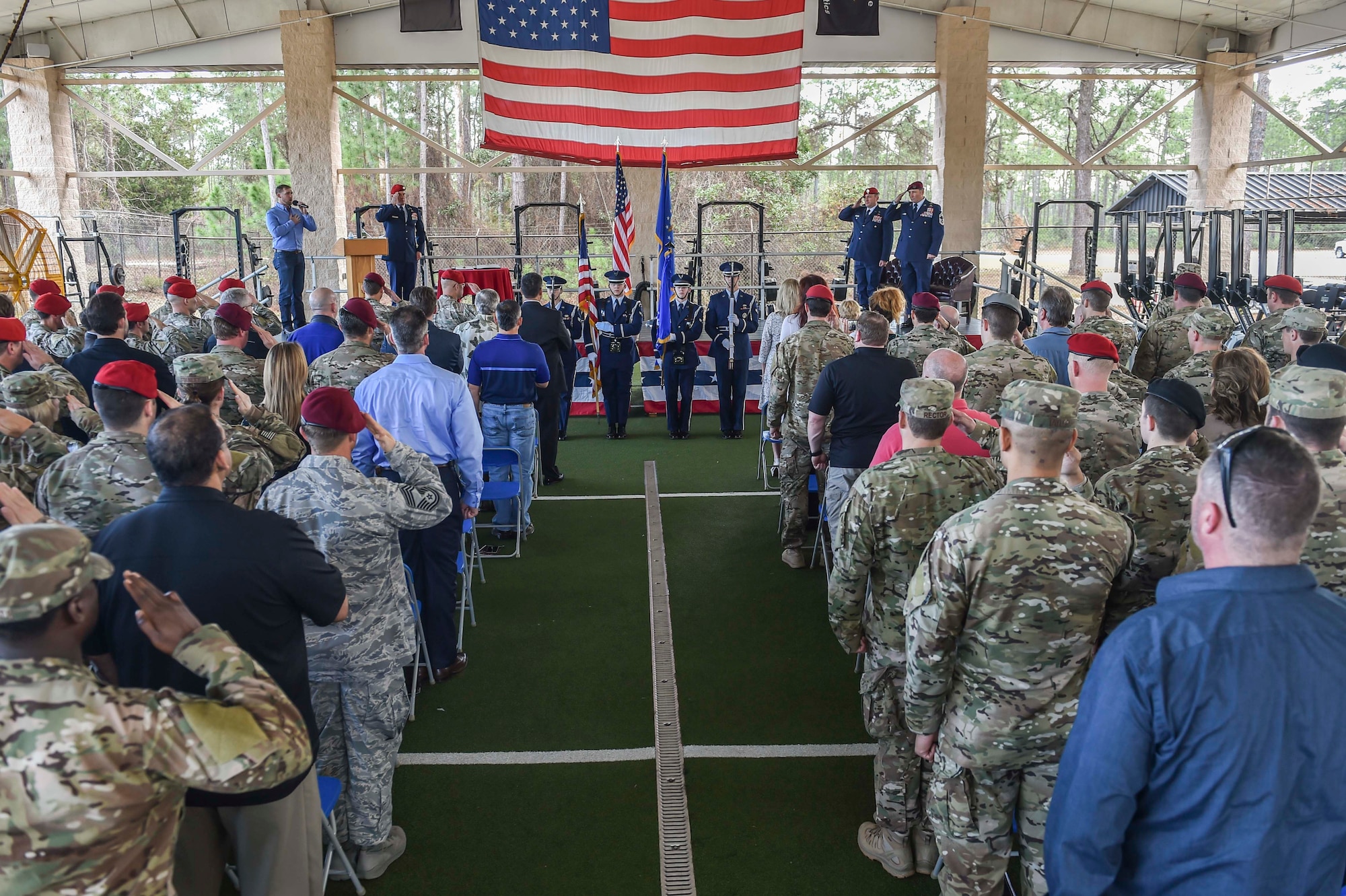 A hundred teammates, friends and family members salute the National Anthem during Chief Master Sgt. Davide Keaton's, superintendent of the 26th Special Tactics Squadron, retirement ceremony at Hurlburt Field, Fla., Jan. 12, 2017. Over the course of Keaton's 30-year career, he was decorated nine times for actions that saved dozens -- if not hundreds-- on and off the battlefield. (U.S. Air Force photo by Senior Airman Ryan Conroy) 