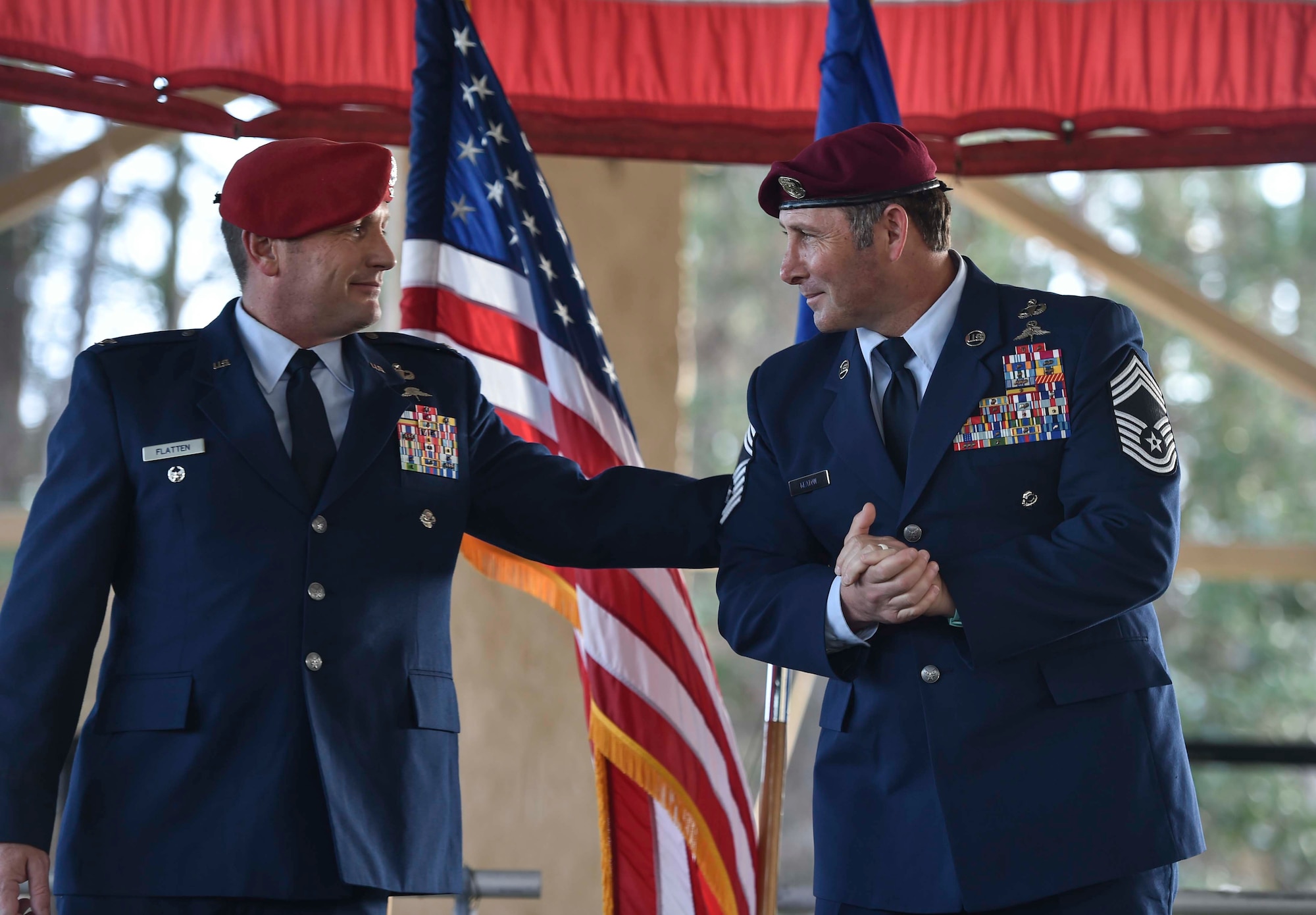 Col. Michael Flatten, vice commander of the 24th Special Operations Wing, pats Chief Master Sgt. Davide Keaton's, superintendent of the 26th Special Tactics Squadron, back during Keaton's retirement ceremony at Hurlburt Field, Fla., Jan. 12, 2017. Over the course of Keaton's 30-year career, he was decorated nine times for actions that saved dozens -- if not hundreds-- on and off the battlefield. (U.S. Air Force photo by Senior Airman Ryan Conroy) 