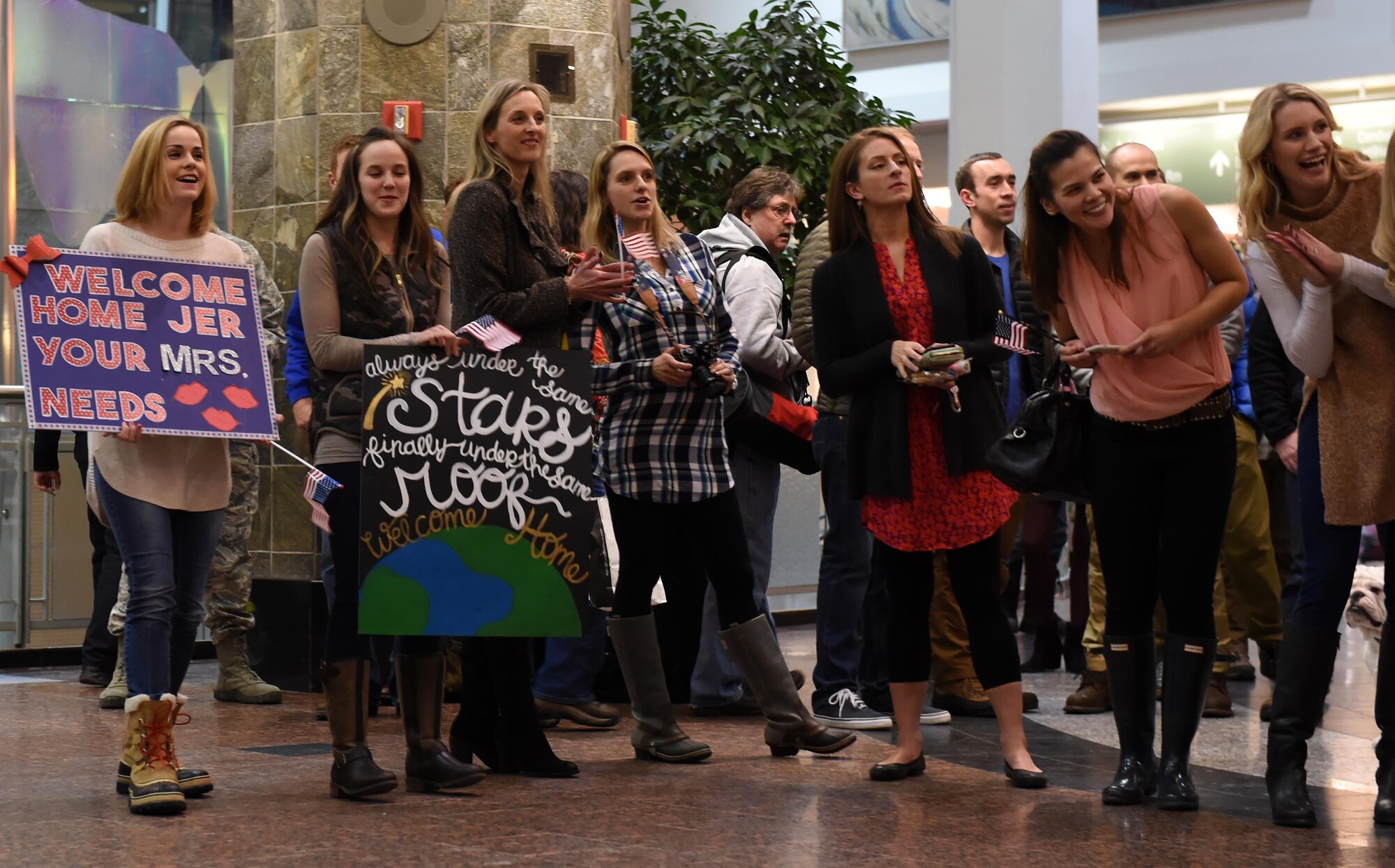 Friends and family await the return of their loved ones at Ted Stevens International Airport, Anchorage, Alaska, Jan. 13, 2016. A group of service members of the 302d Fighter Squadron and the 525th Fighter Squadron returned from a deployment to Southwest Asia.