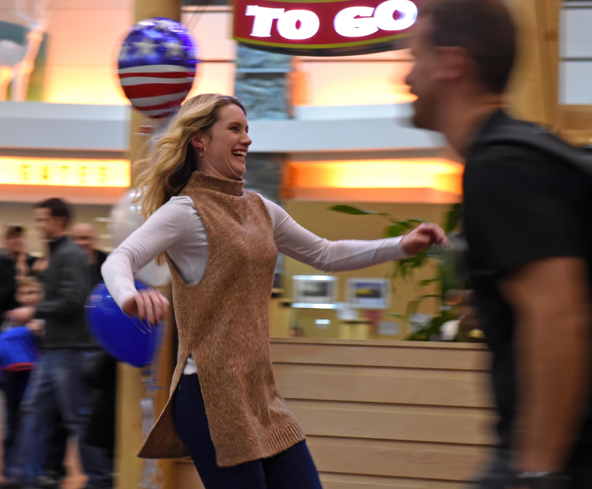 Charlotte Autrey runs toward her spouse who has returned from a deployment at the Ted Stevens International Airport, Anchorage, Alaska, Jan. 13, 2017. Airmen of the 302d Fighter Squadron and the 525th Fighter Squadron returned from a deployment to Southwest Asia. 