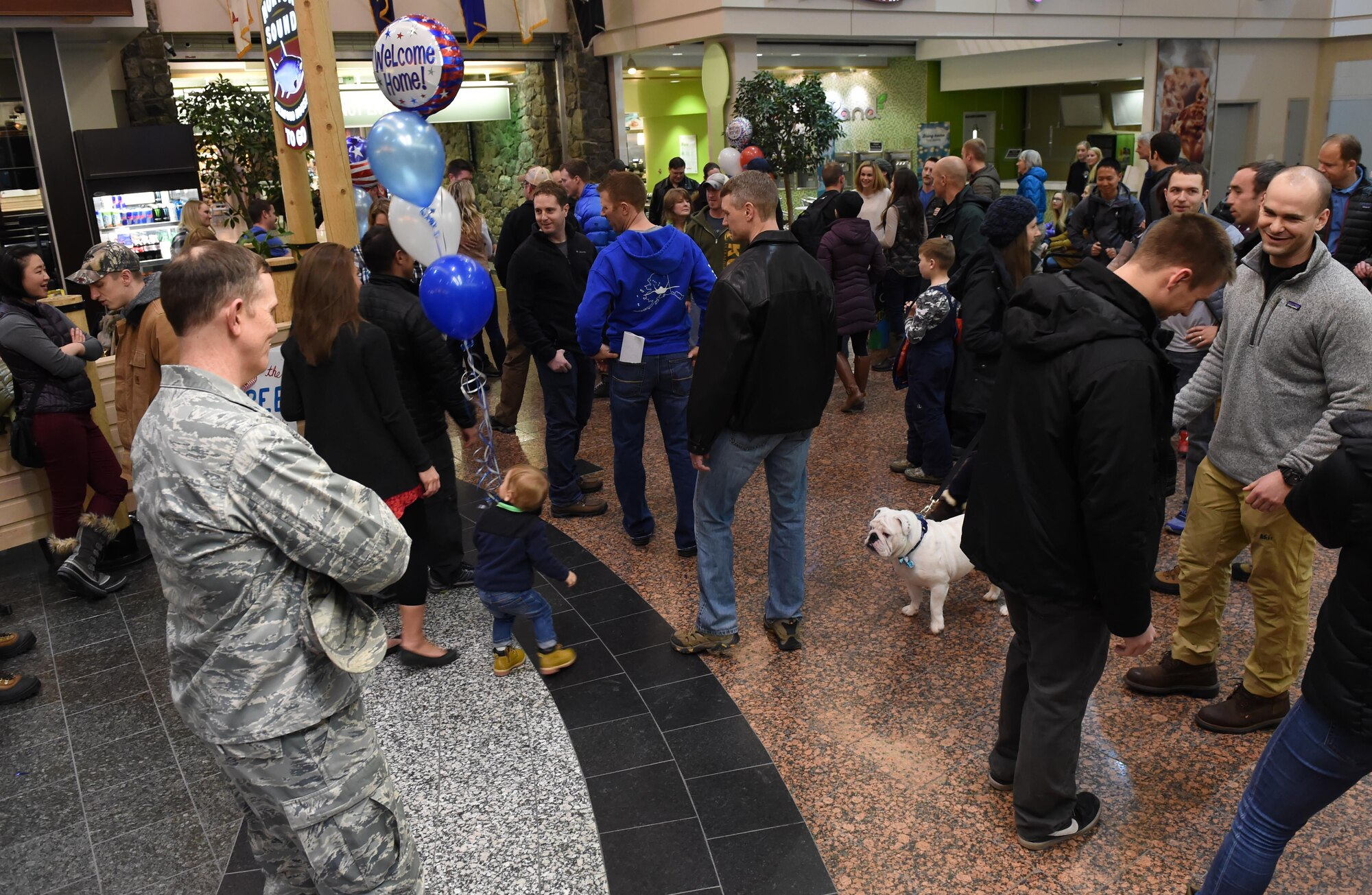 Friends and family are reunited with their loved ones as JBER Airmen return from a deployment at Ted Stevens International Airport, Anchorage, Alaska, Jan. 13, 2016. Airmen of the 302d Fighter Squadron and the 525th Fighter Squadron returned from a deployment to Southwest Asia. 